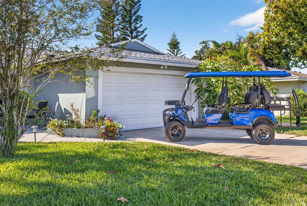 The exterior of a house features a concrete patio, landscaping, and a front entrance — 12620 138TH STREET N, LARGO, FL