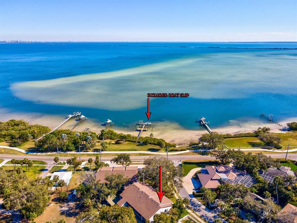An aerial view shows a house, a road, and a boat slip on the water — 413 S BAYSHORE BOULEVARD UNIT 4, SAFETY HARBOR, FL
