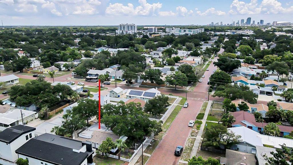 An aerial view shows a residential neighborhood with a red arrow pointing to a house — 3829 2ND AVENUE N, ST PETERSBURG, FL