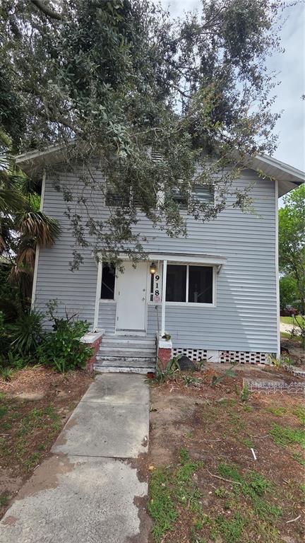 A two-story house with light gray siding and a concrete walkway leading to the entrance — 918 E LIME STREET UNIT 1, LAKELAND, FL