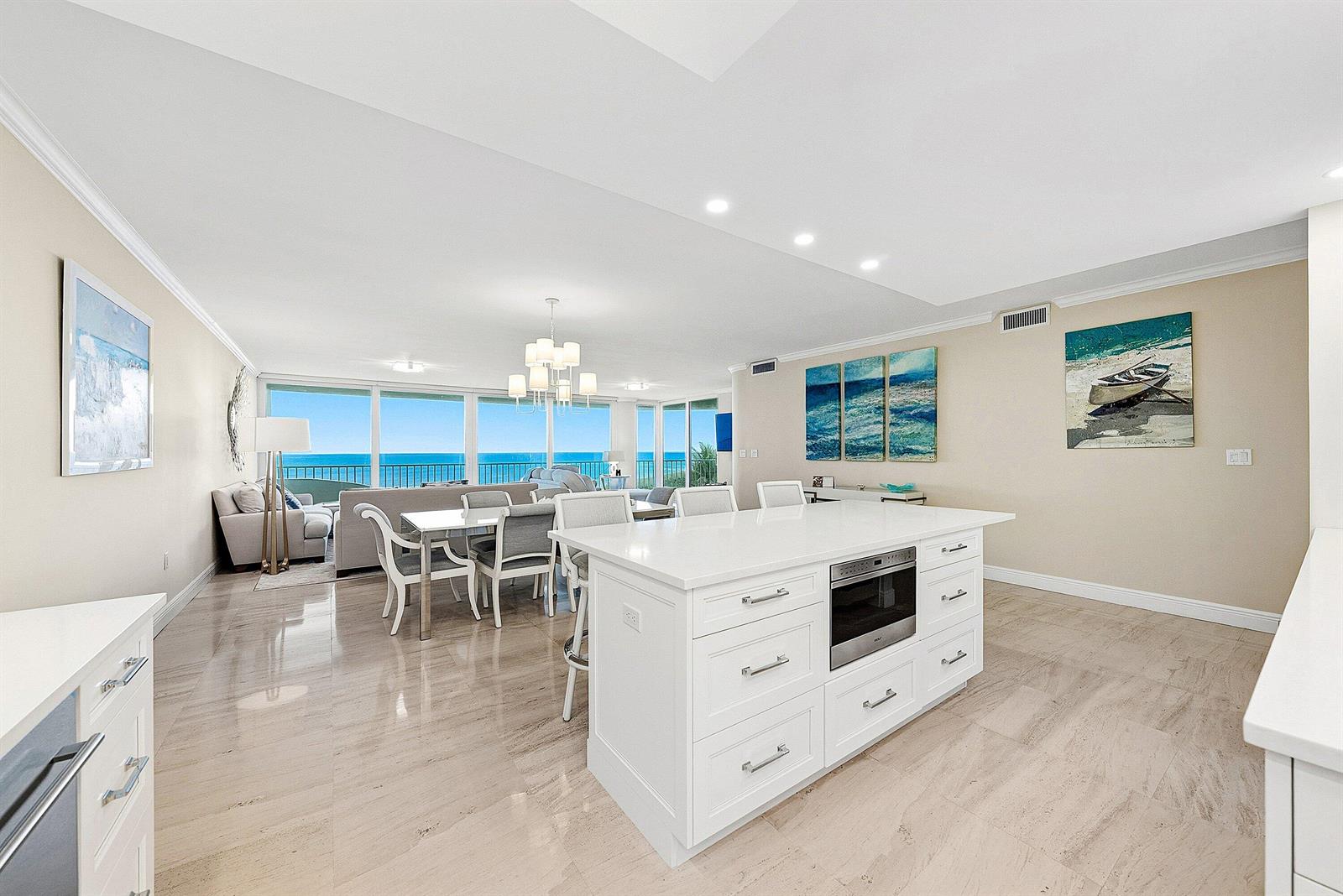 A white kitchen island sits in an open-concept living area with ocean views — 2001 SE Sailfish Point Boulevard # 313, Stuart FL 34996, STUART, FL