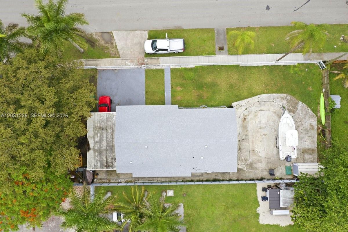 An aerial view shows a house with a driveway, a boat, and a grassy yard — 300 SW 8th Ave, Florida City FL 33034, FLORIDA CITY, FL