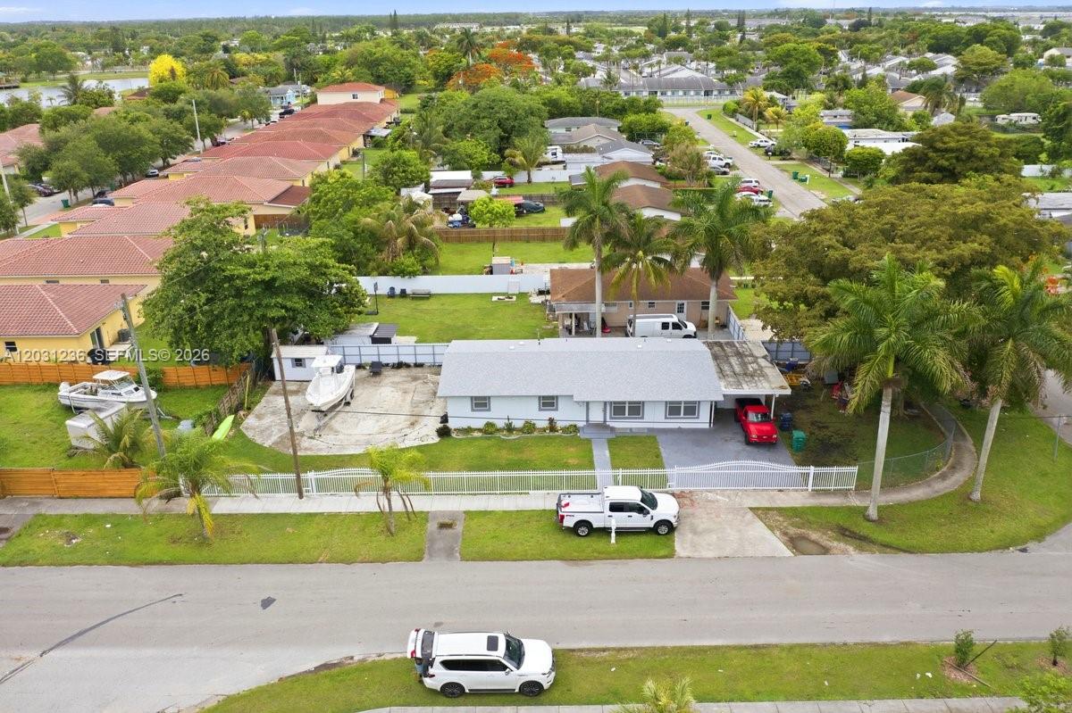 An aerial view shows a single-story house with a large yard, boat, and driveway — 300 SW 8th Ave, Florida City FL 33034, FLORIDA CITY, FL