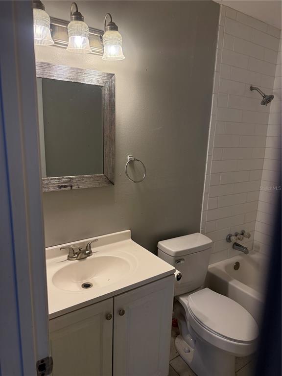 A bathroom with a white vanity, toilet, and a shower-tub combination with white subway tile — 500 E 25TH STREET, SANFORD, FL