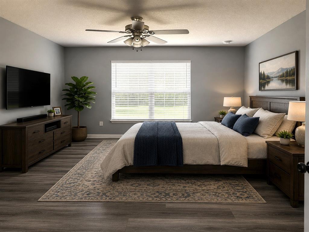A bedroom features gray walls, wood-look flooring, a ceiling fan, and a dark wood bed frame — 4406 OLYMPIA COURT, CLERMONT, FL