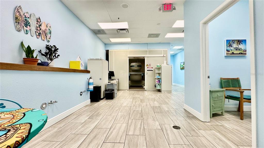 A medical imaging room features light blue walls, wood-look tile flooring, and an MRI machine — 2301 STATE ROAD 524 UNIT A135, COCOA, FL