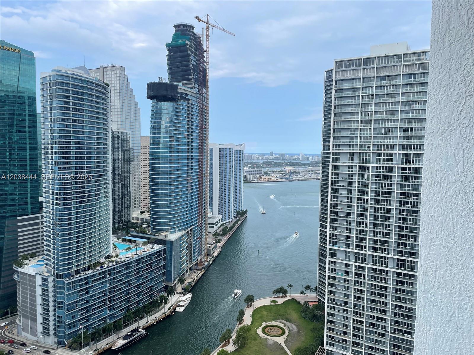 An elevated view of a Miami canal flanked by modern high-rise residential buildings — 55 SE 6th St, Miami FL 33131, MIAMI, FL