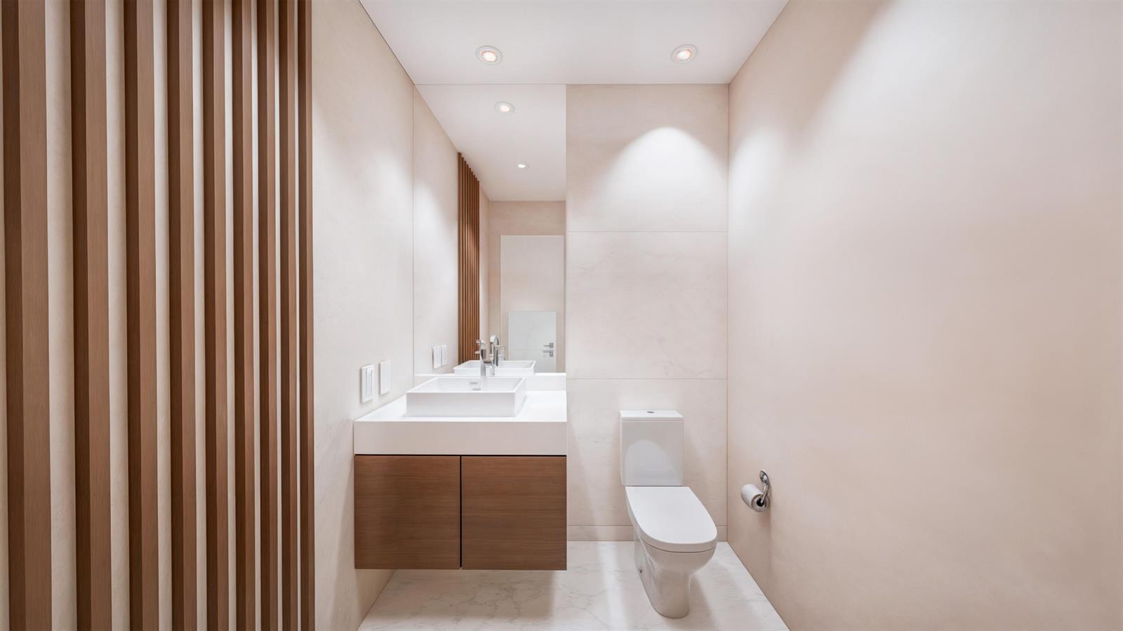 A modern bathroom features a floating wood vanity, a white vessel sink, and vertical wood slats — 1210 Aryana Way, Delray Beach FL 33445, DELRAY BEACH, FL