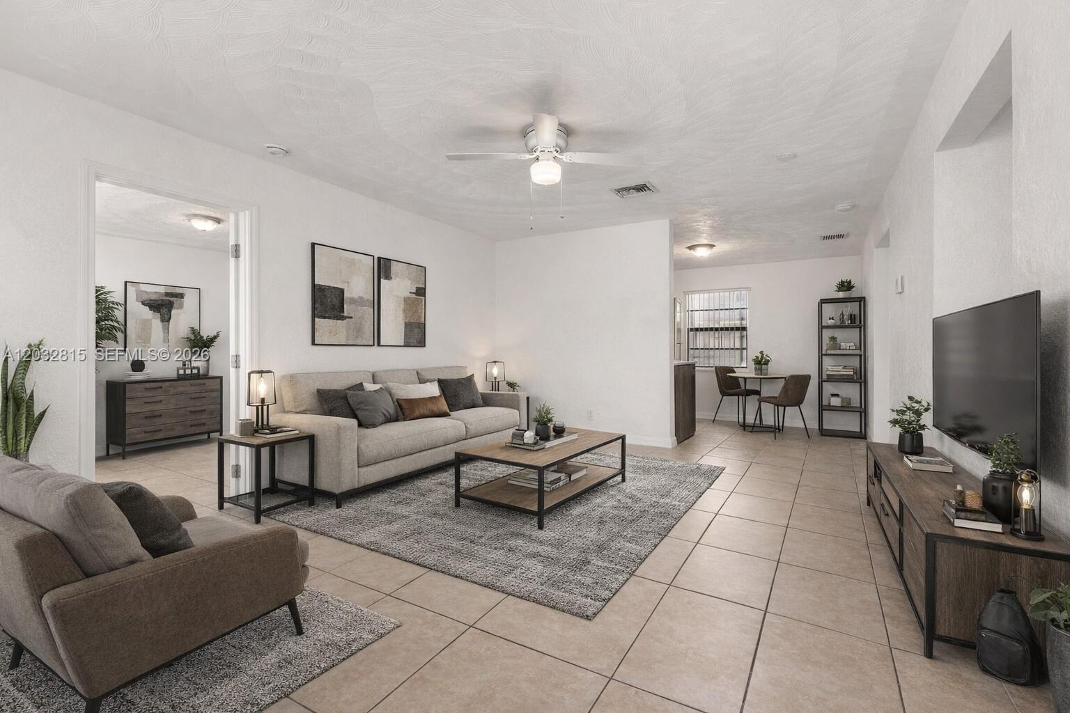 A living room features a grey sofa, a coffee table, and tile flooring — 4120 SW 19th St, West Park FL 33023, WEST PARK, FL