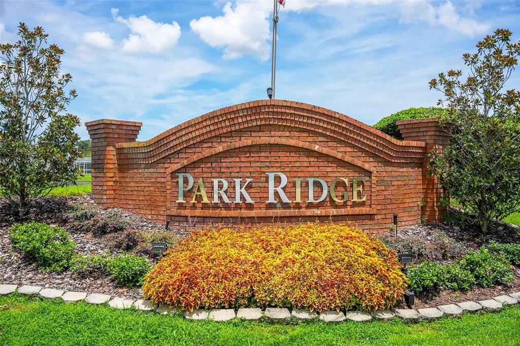 A brick monument sign with the words Park Ridge sits in a landscaped garden — 1025 GREEN RIDGE COURT, MINNEOLA, FL