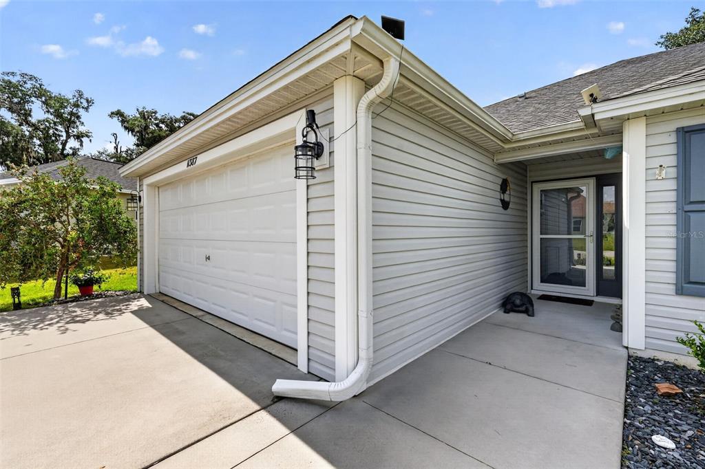 An aerial view shows a residential house with solar panels and a large fenced yard — 11387 ZIMMERMAN PATH, OXFORD, FL