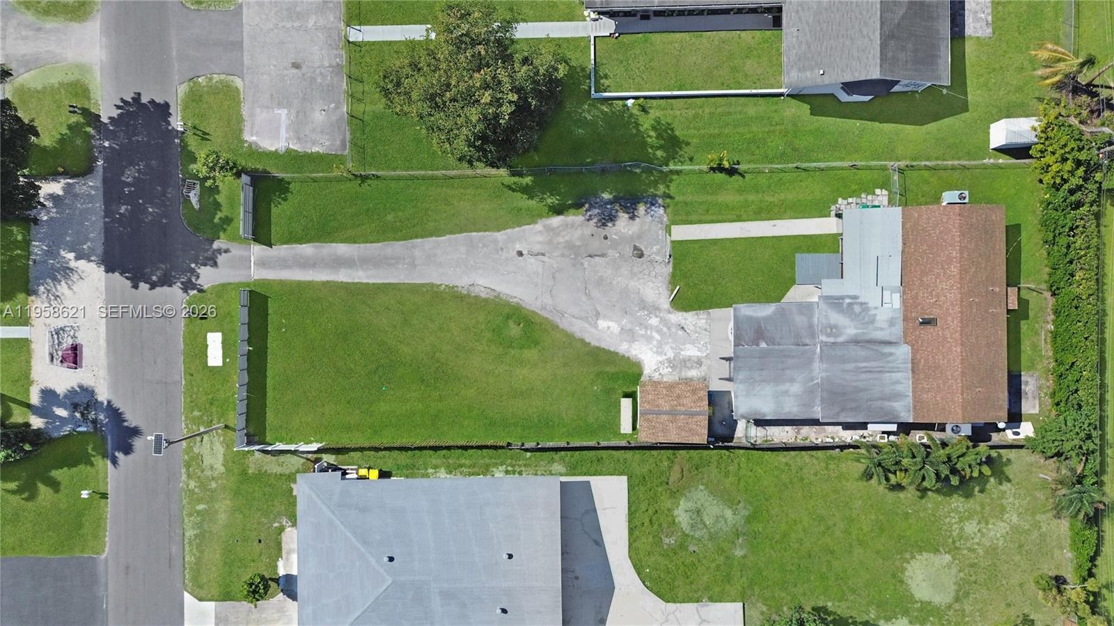 An aerial view shows a residential neighborhood with low-rise apartment buildings and single-family homes — 4133 SW 52nd St, Dania Beach FL 33314, DANIA BEACH, FL
