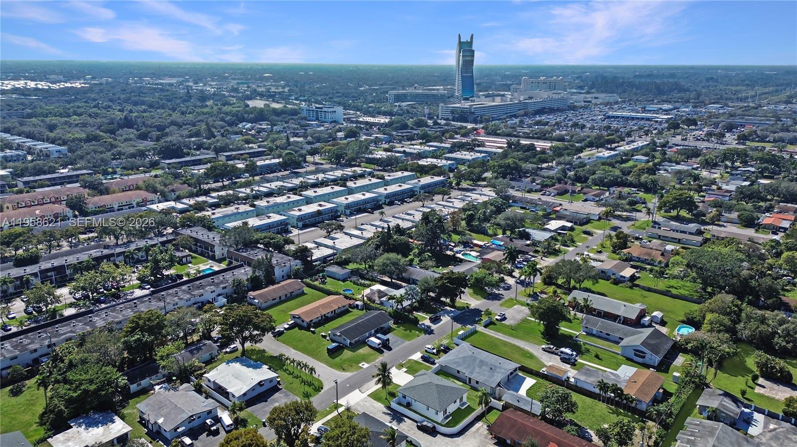 An aerial view shows a residential neighborhood with houses, streets, and green spaces — 4133 SW 52nd St, Dania Beach FL 33314, DANIA BEACH, FL
