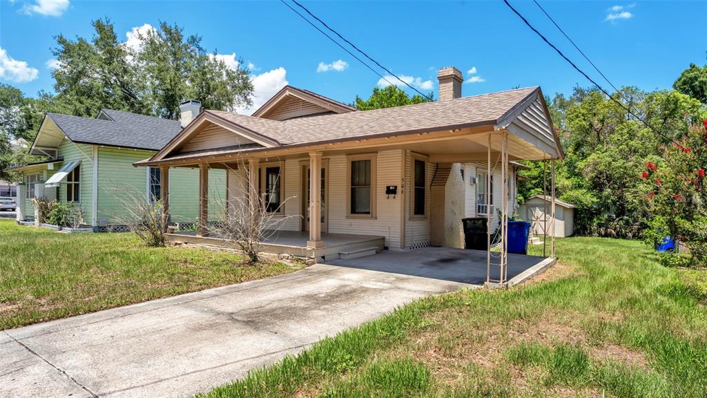 A single-story house with a front porch, attached carport, and a concrete driveway — 506 S MCKAY AVENUE, LAKELAND, FL