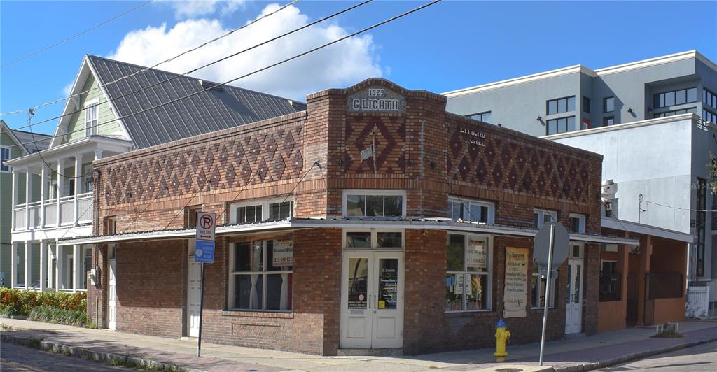 A historic 1925 brick commercial building with decorative masonry sits on a street corner — 1623 E 5TH AVENUE, TAMPA, FL