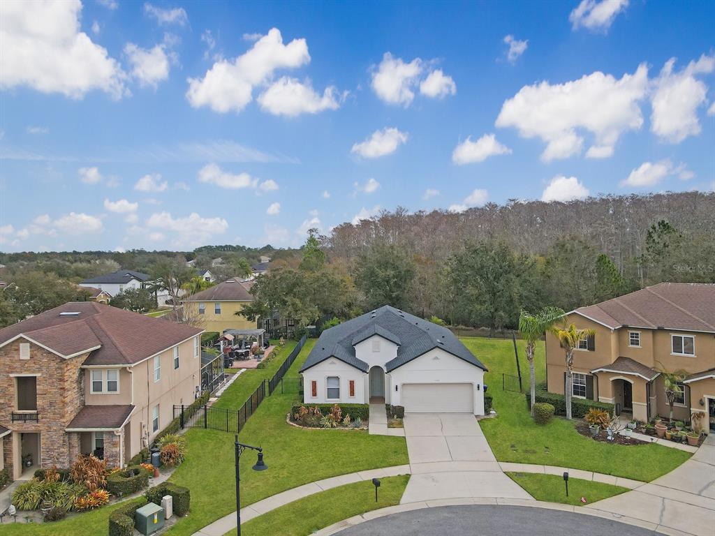 An aerial view shows a single-story house with a two-car garage and a fenced yard — 13313 HALKYN POINT, ORLANDO, FL