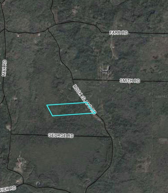 This is an aerial map showing a property parcel outlined in blue near local roads — TBD ROCK ISLAND ROAD, PERRY, FL