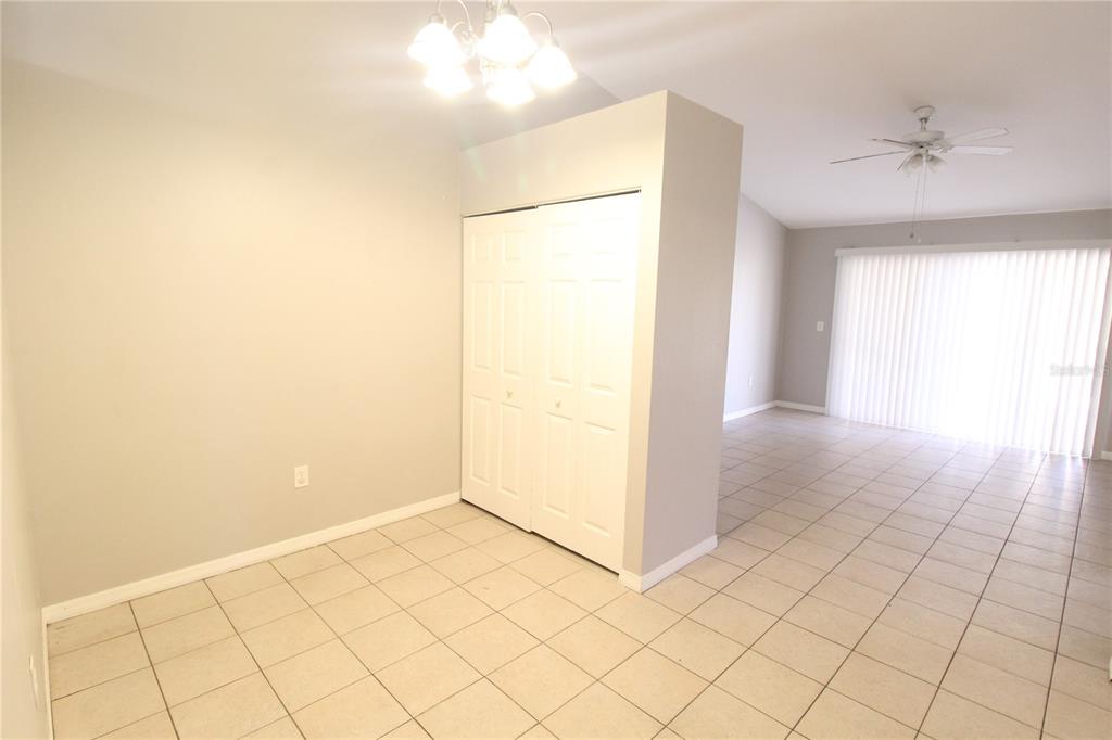 A dining area with tile flooring, a white closet, and a ceiling light fixture — 864 HAND AVE, SARASOTA, FL