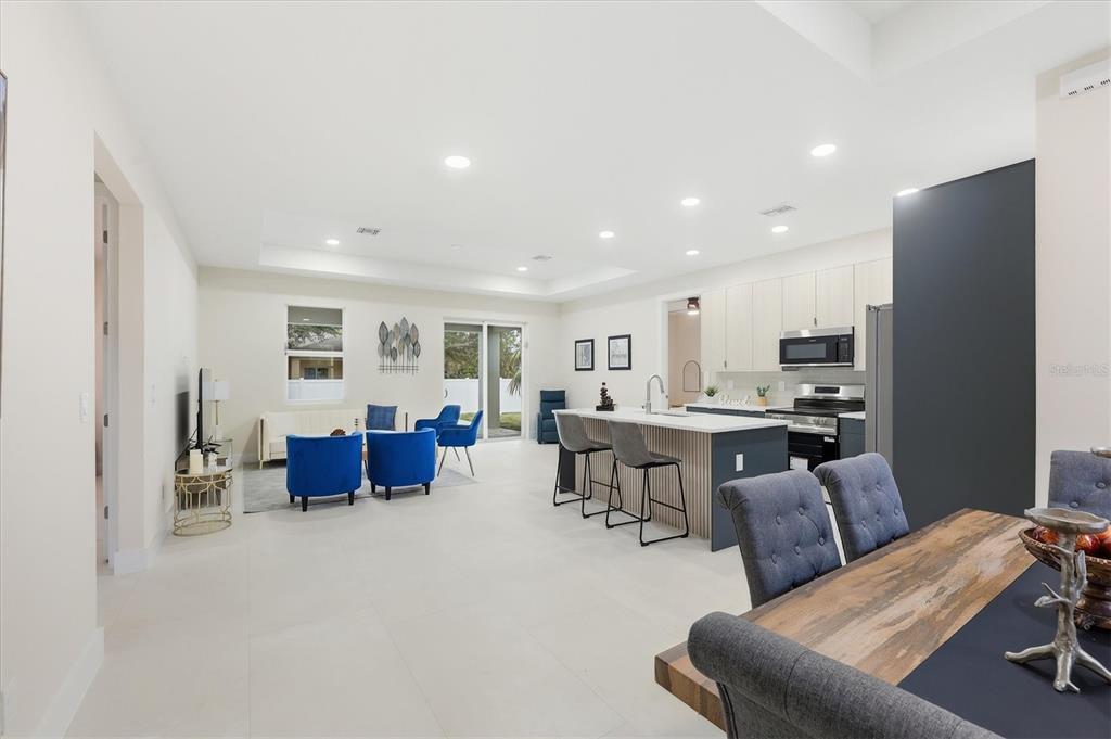 An open-concept living area features a kitchen with an island, dining space, and living room — 2658 ALLSUP TERRACE, NORTH PORT, FL