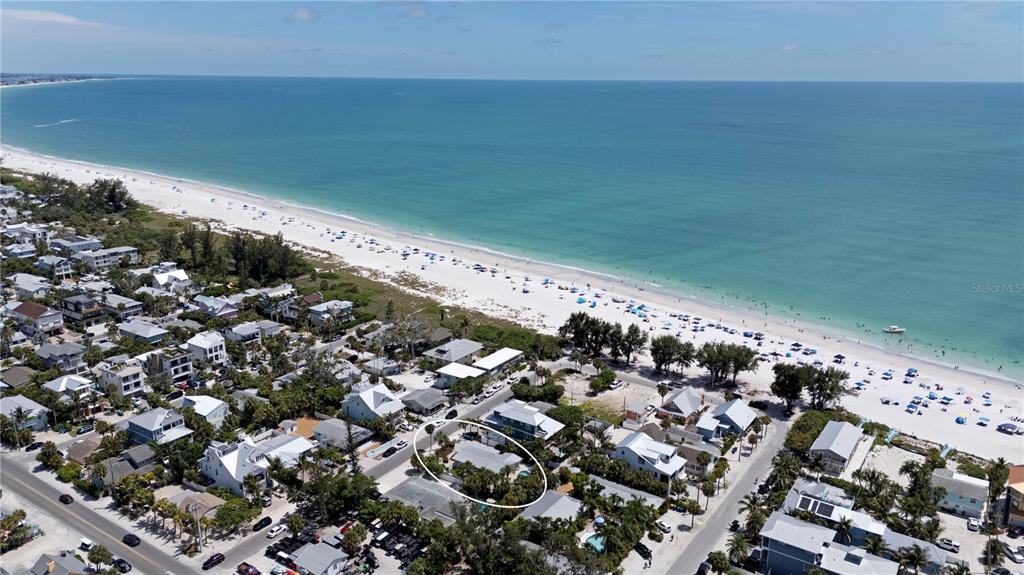An aerial view shows a beachside neighborhood with a circled house near the shoreline — 110 PALM AVENUE, ANNA MARIA, FL
