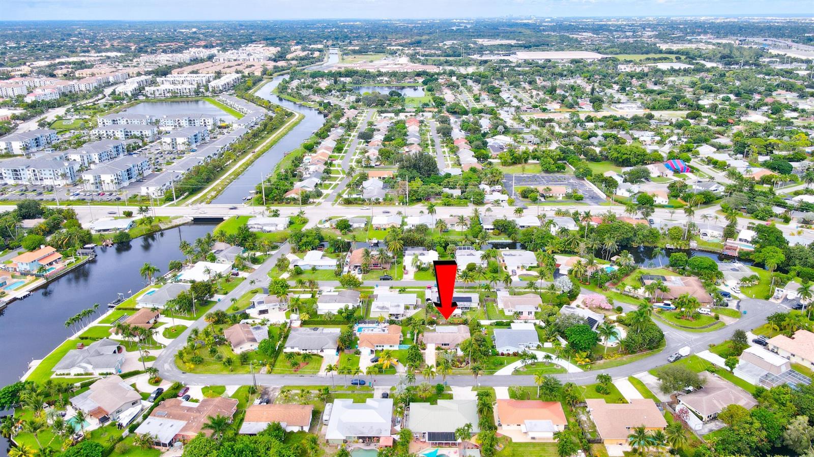 An aerial view shows a residential neighborhood with a red arrow pointing to a house — 1036 Coral Drive, Boynton Beach FL 33426, BOYNTON BEACH, FL