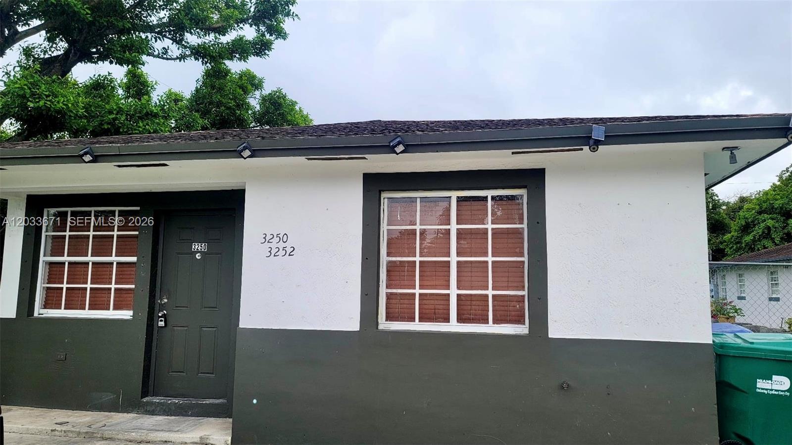 An empty room with beige tile flooring, white walls, and a window with blinds — 3250 NW 94 ST # 0, Miami FL 33147, MIAMI, FL