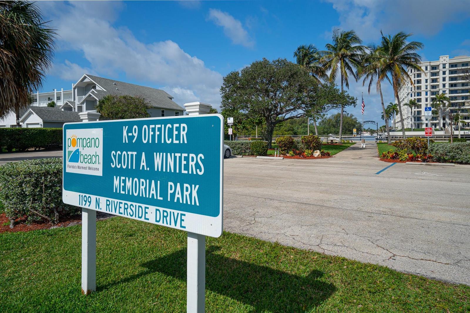 A green sign identifies the K-9 Officer Scott A. Winters Memorial Park near a parking lot — 1110 N Riverside Drive # 20, Pompano Beach FL 33062, POMPANO BEACH, FL