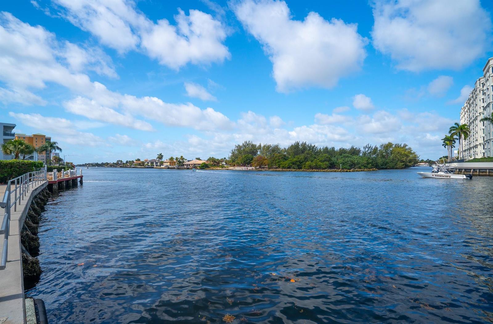 A view of a calm waterway bordered by a concrete walkway and residential buildings — 1110 N Riverside Drive # 20, Pompano Beach FL 33062, POMPANO BEACH, FL