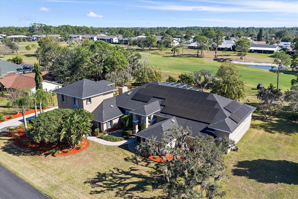 An aerial view of a house with solar panels on the roof near a golf course — 3416 SUNRISE DRIVE, SEBRING, FL