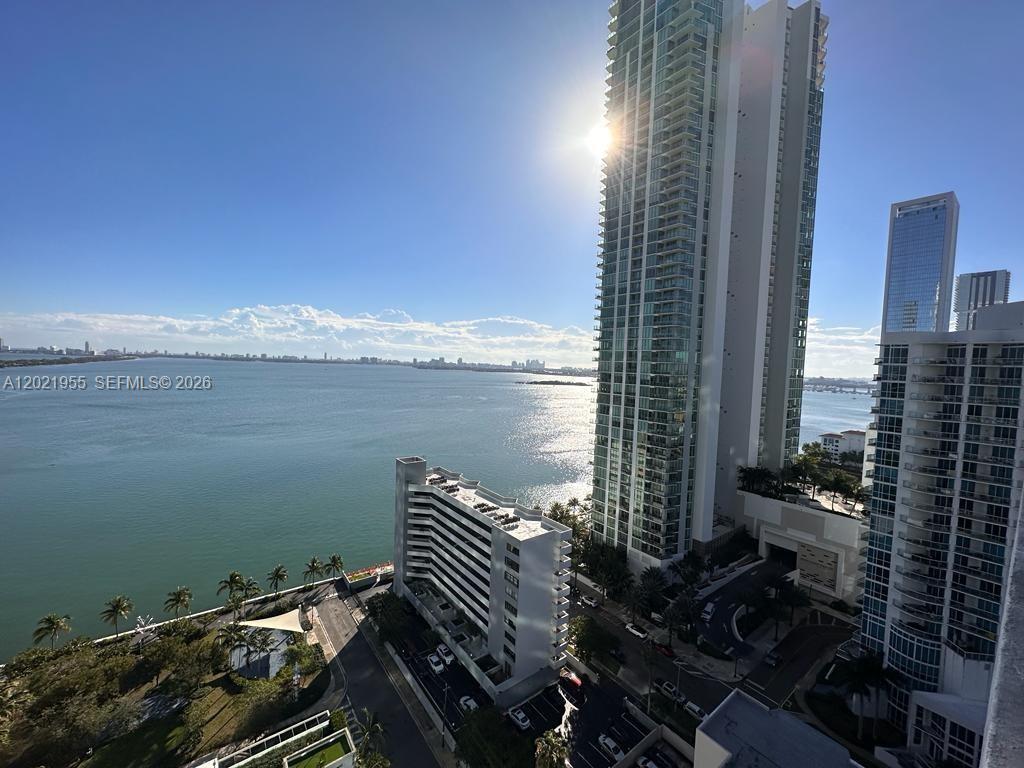 An elevated view shows a bay, palm trees, and several high-rise residential buildings — 480 NE 31st St # 1902, Miami FL 33137, MIAMI, FL