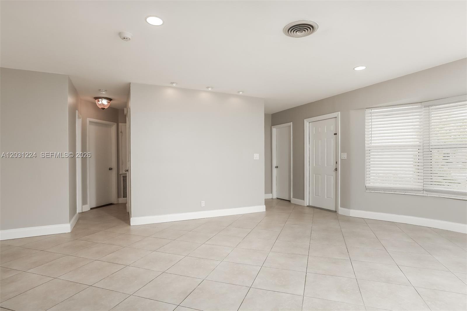 This room features light gray walls, tiled flooring, recessed lighting, and two white interior doors — 6119 NW 18th Ct, Margate FL 33063, MARGATE, FL