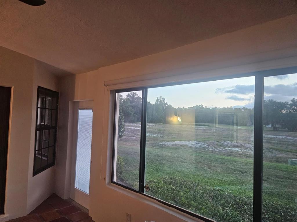 A room with a large window overlooking a grassy field and a glass door — 123 COVENTRY LANE, HAINES CITY, FL