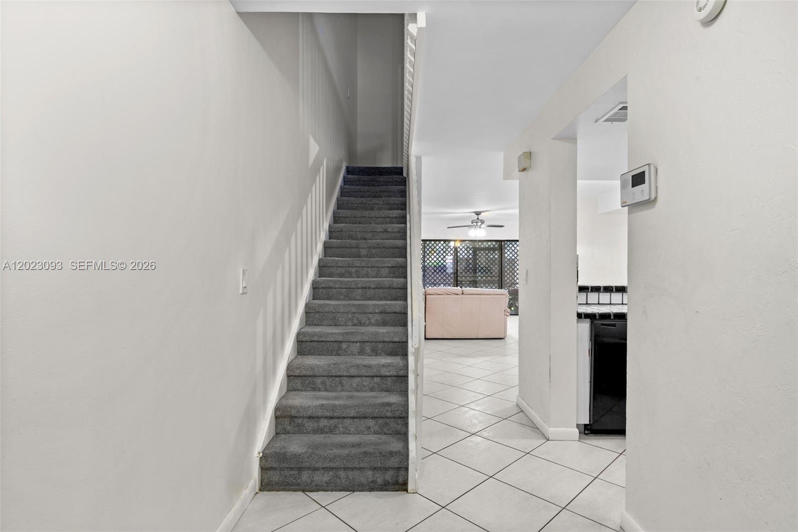A carpeted staircase leads upward next to a tiled hallway and an open living area — 4241 SW 71st Way # 4241, Davie FL 33314, DAVIE, FL