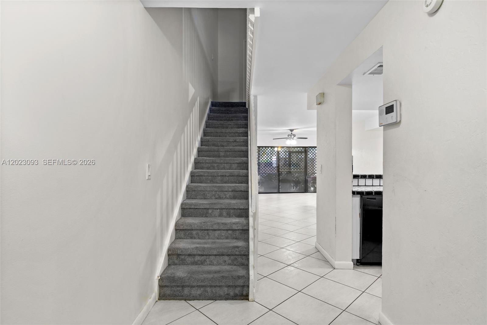 A carpeted staircase leads upward next to a tiled hallway and kitchen area — 4241 SW 71st Way # 4241, Davie FL 33314, DAVIE, FL