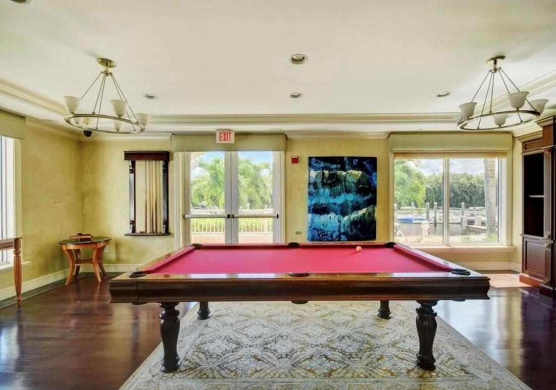 A billiards room features a red pool table, a patterned rug, and large windows overlooking water — 804 E Windward Way # 316, Lantana FL 33462, LANTANA, FL