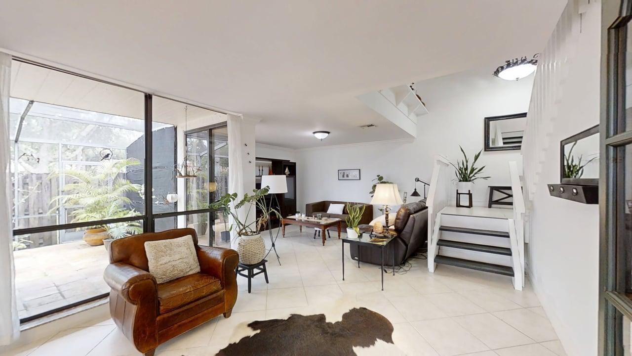 A living room features tile floors, a leather armchair, a sofa, and a staircase — 5803 Fox Hollow Drive # B, Boca Raton FL 33486, BOCA RATON, FL