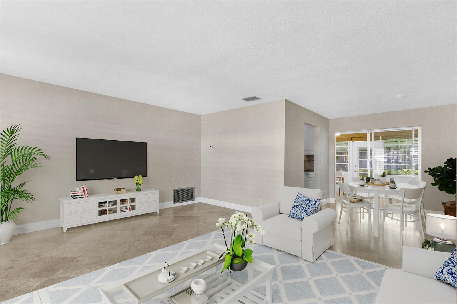 A living room features a television, white media console, armchair, and dining area with tile floors — 110 NW 24th Court, Pompano Beach FL 33064, POMPANO BEACH, FL