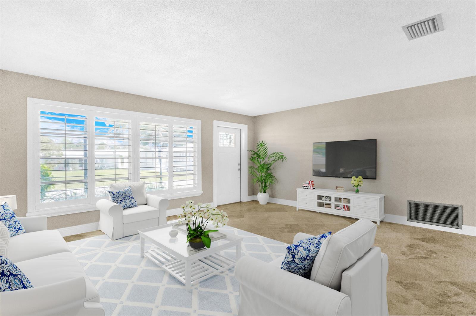 A living room features white furniture, a patterned area rug, and a wall-mounted television — 110 NW 24th Court, Pompano Beach FL 33064, POMPANO BEACH, FL