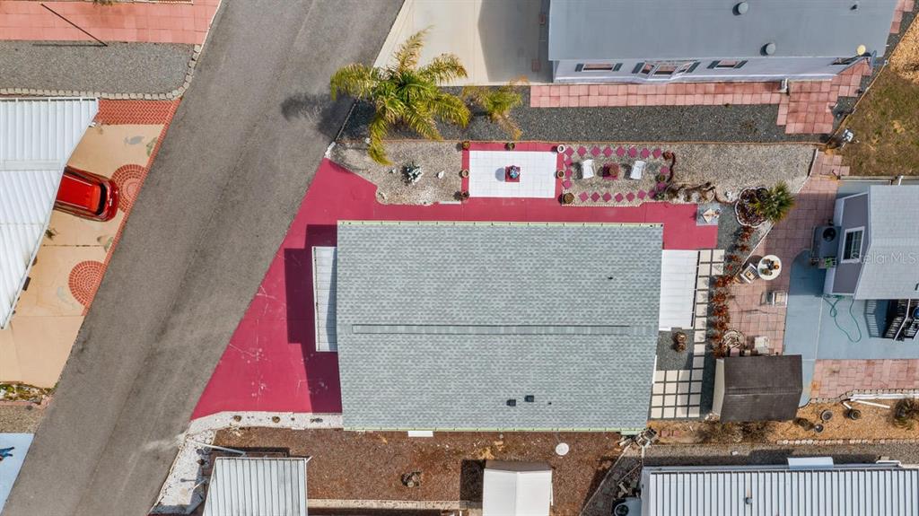 An aerial view shows a house with a gray roof, red driveway, and landscaped yard — 251 PATTERSON ROAD UNIT A27, HAINES CITY, FL