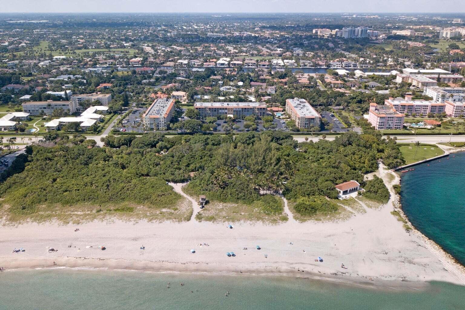 An aerial view of a beach, dense vegetation, and several multi-story apartment buildings — 950 Ponce De Leon Road # 309, Boca Raton FL 33432, BOCA RATON, FL