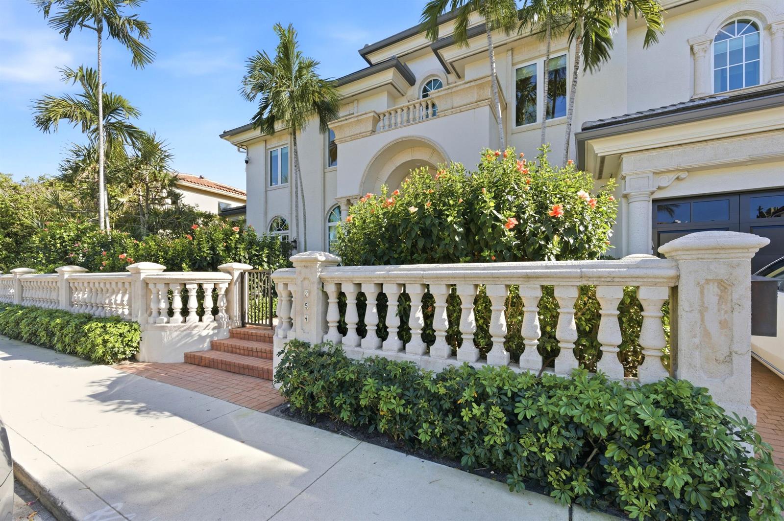 A two-story house with a stone balustrade fence, palm trees, and a brick entrance path — 254 Atlantic Avenue, Palm Beach FL 33480, PALM BEACH, FL