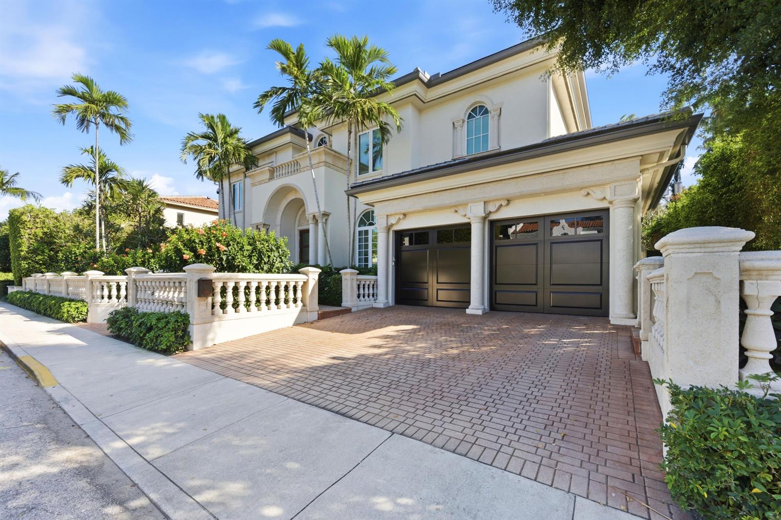 A two-story house with a brick driveway, two garage doors, and a stone balustrade fence — 254 Atlantic Avenue, Palm Beach FL 33480, PALM BEACH, FL
