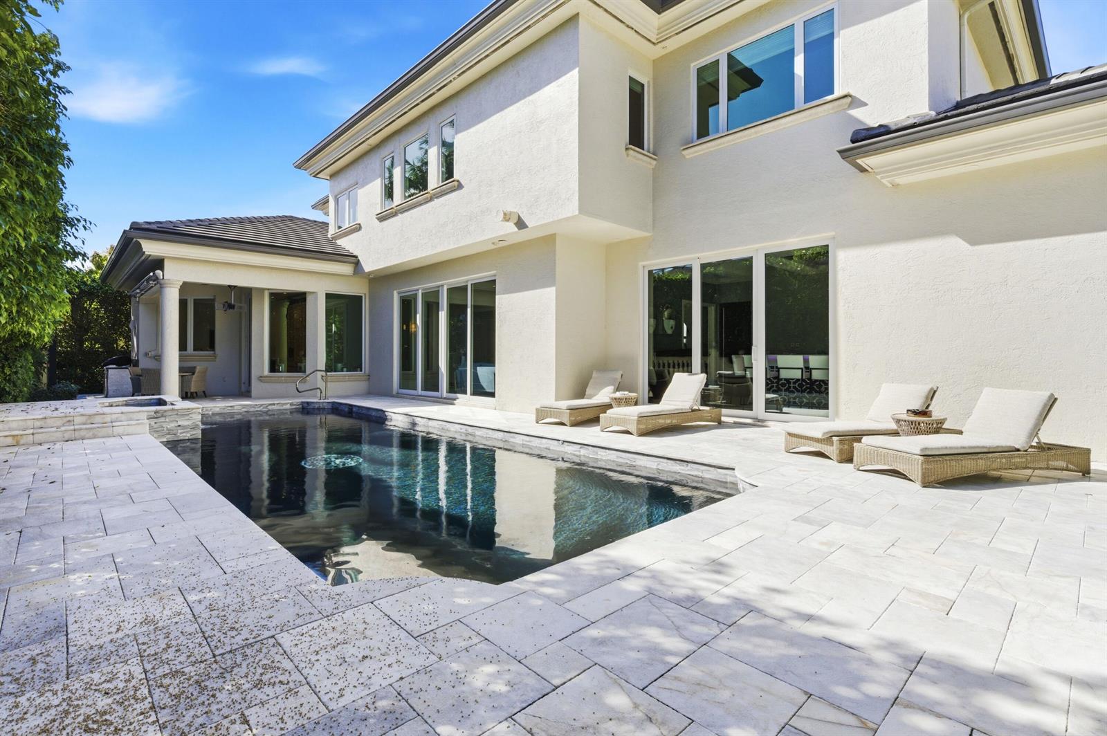 A two-story house with a swimming pool and lounge chairs on a stone patio — 254 Atlantic Avenue, Palm Beach FL 33480, PALM BEACH, FL