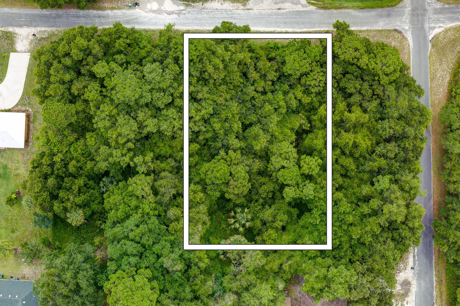An aerial view shows a rectangular lot outlined in white amidst a dense wooded area — 47 N St, Fort Pierce FL 34946, FORT PIERCE, FL