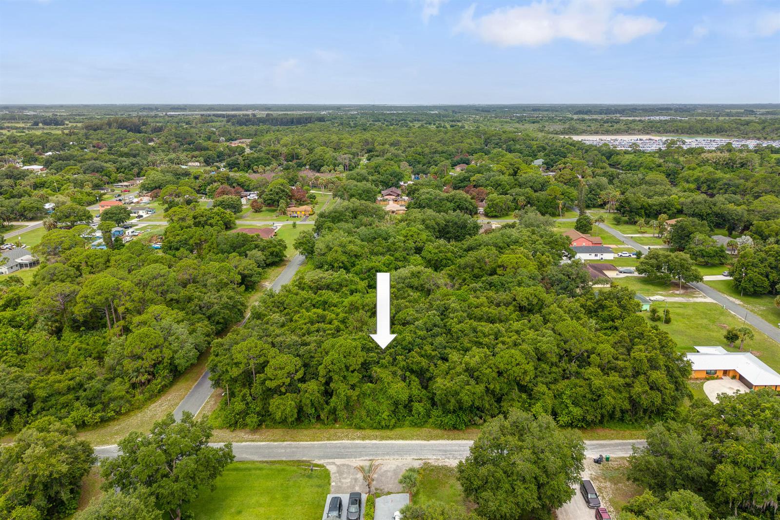 An aerial view shows a wooded, undeveloped rectangular lot surrounded by residential houses and streets — 47 N St, Fort Pierce FL 34946, FORT PIERCE, FL