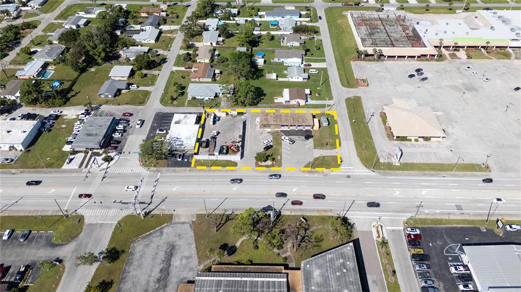 An aerial view shows a commercial property outlined in yellow along a multi-lane road — 334 S INDIANA AVENUE, ENGLEWOOD, FL