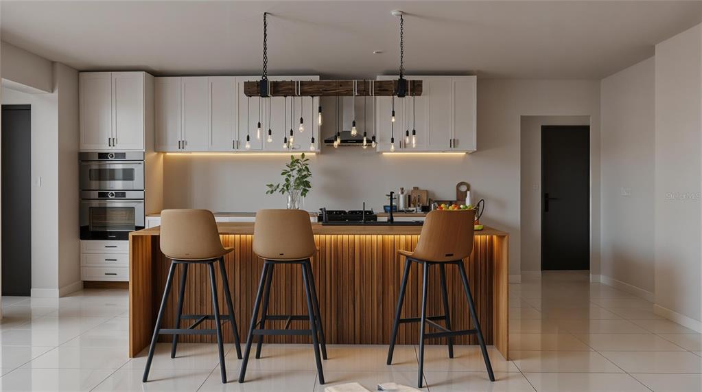 A modern kitchen features white cabinetry, a wood-paneled island with bar stools, and pendant lighting — 16444 CALDWELL LANE, SPRING HILL, FL