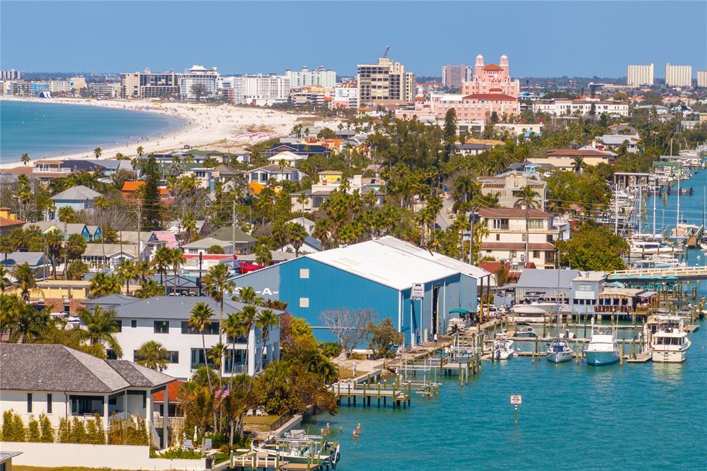 An aerial view of a multi-story white house with a metal roof near the water — 1801 PASS A GRILLE WAY, ST PETE BEACH, FL