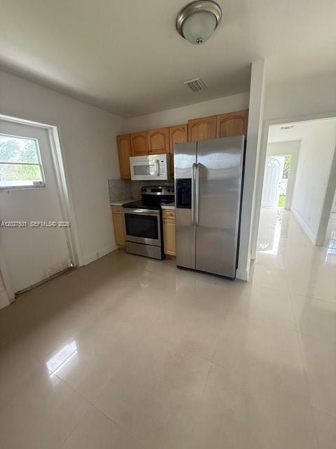 A kitchen with light wood cabinets, stainless steel appliances, and light-colored tile flooring — 3700 SW 56TH AVE # 3700, West Park FL 33023, WEST PARK, FL