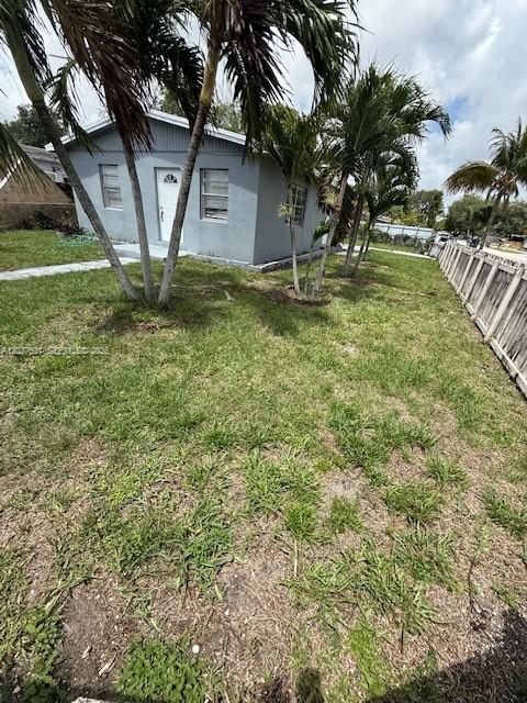 A gray single-story house sits on a grassy lot with palm trees and a fence — 3700 SW 56TH AVE # 3700, West Park FL 33023, WEST PARK, FL